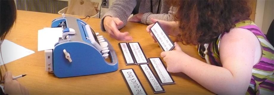 Child testing font sizes on brailler prototype